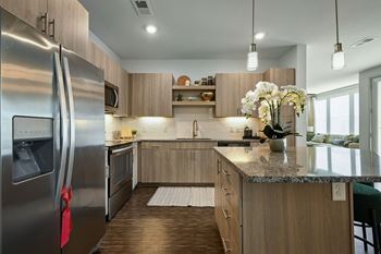a kitchen with stainless steel appliances and wooden cabinets